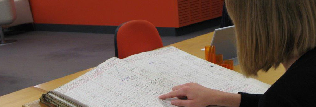 A volunteer reading an archival book 