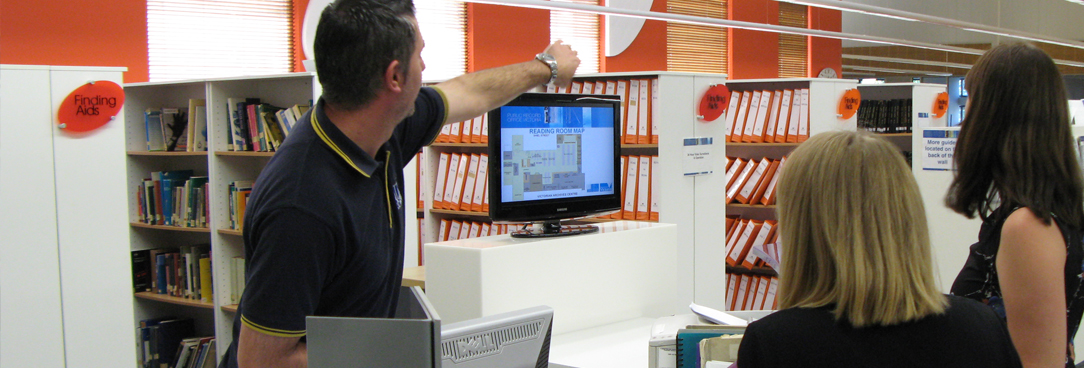 Support staff at help desk in archive