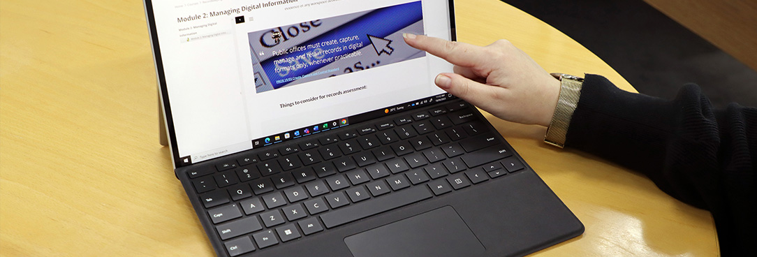 a person's hand on the computer