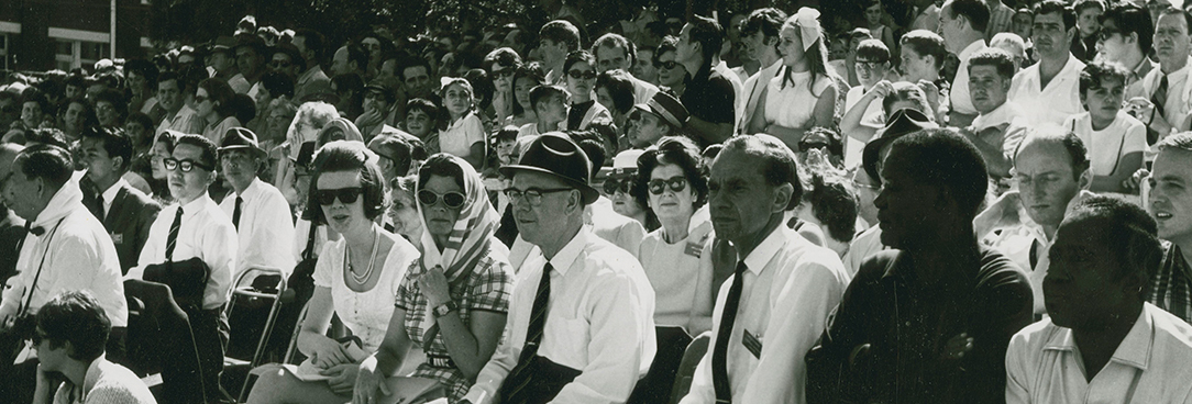 a crowd of people seated watching an event