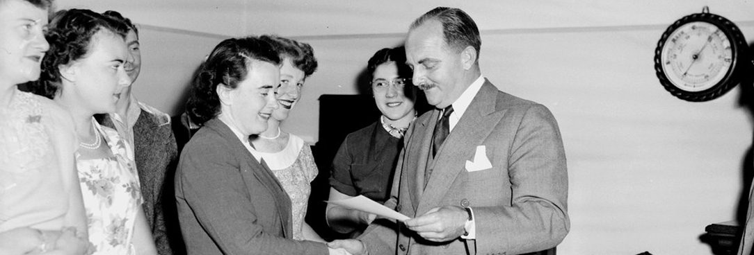 a man giving people certififcates