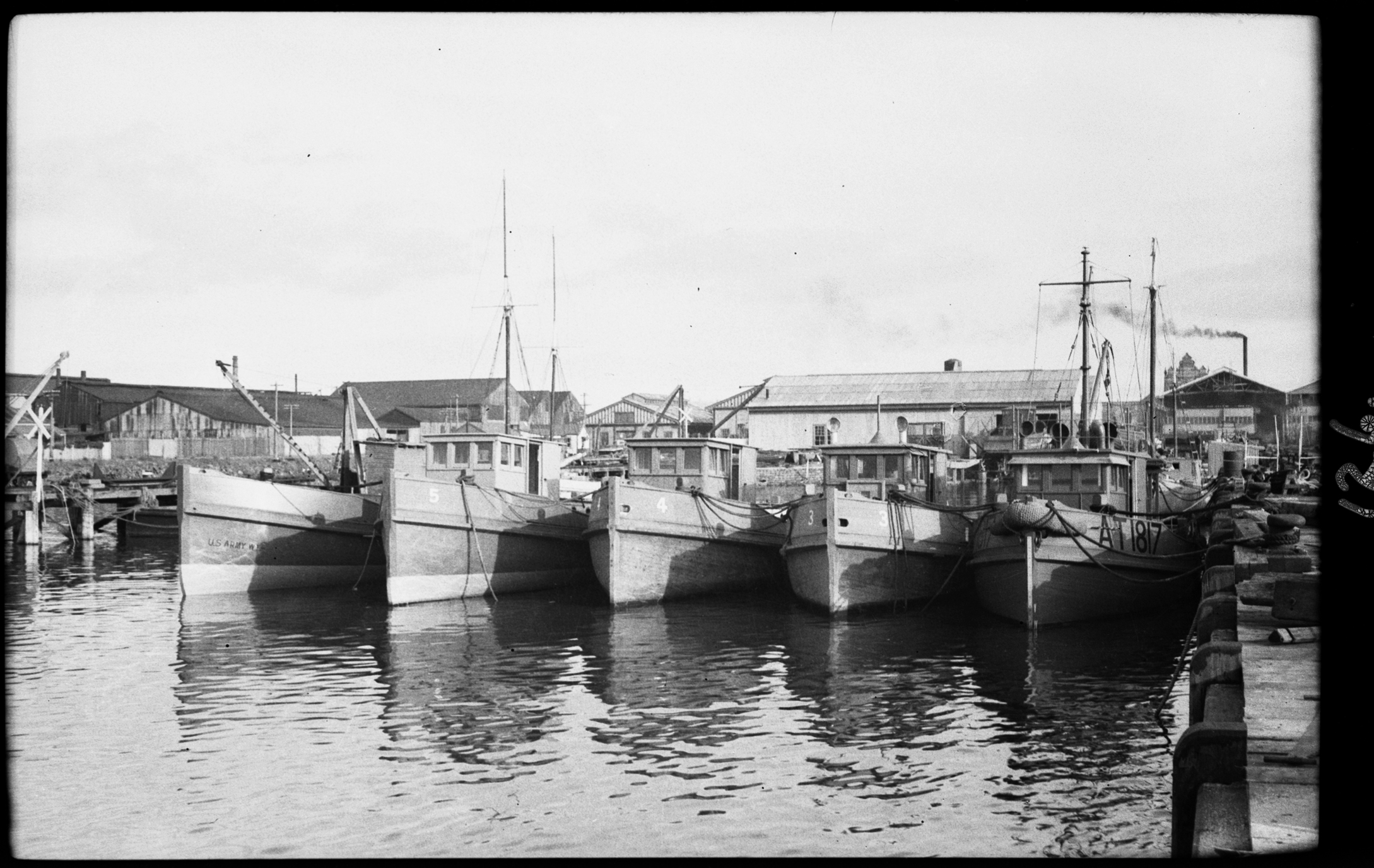 black and white photo of boats docked