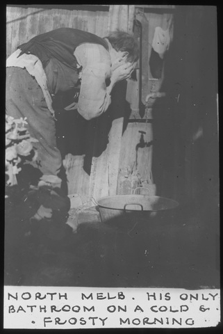 Black and white photo of poor man in 1930s washing face in North Melbourne
