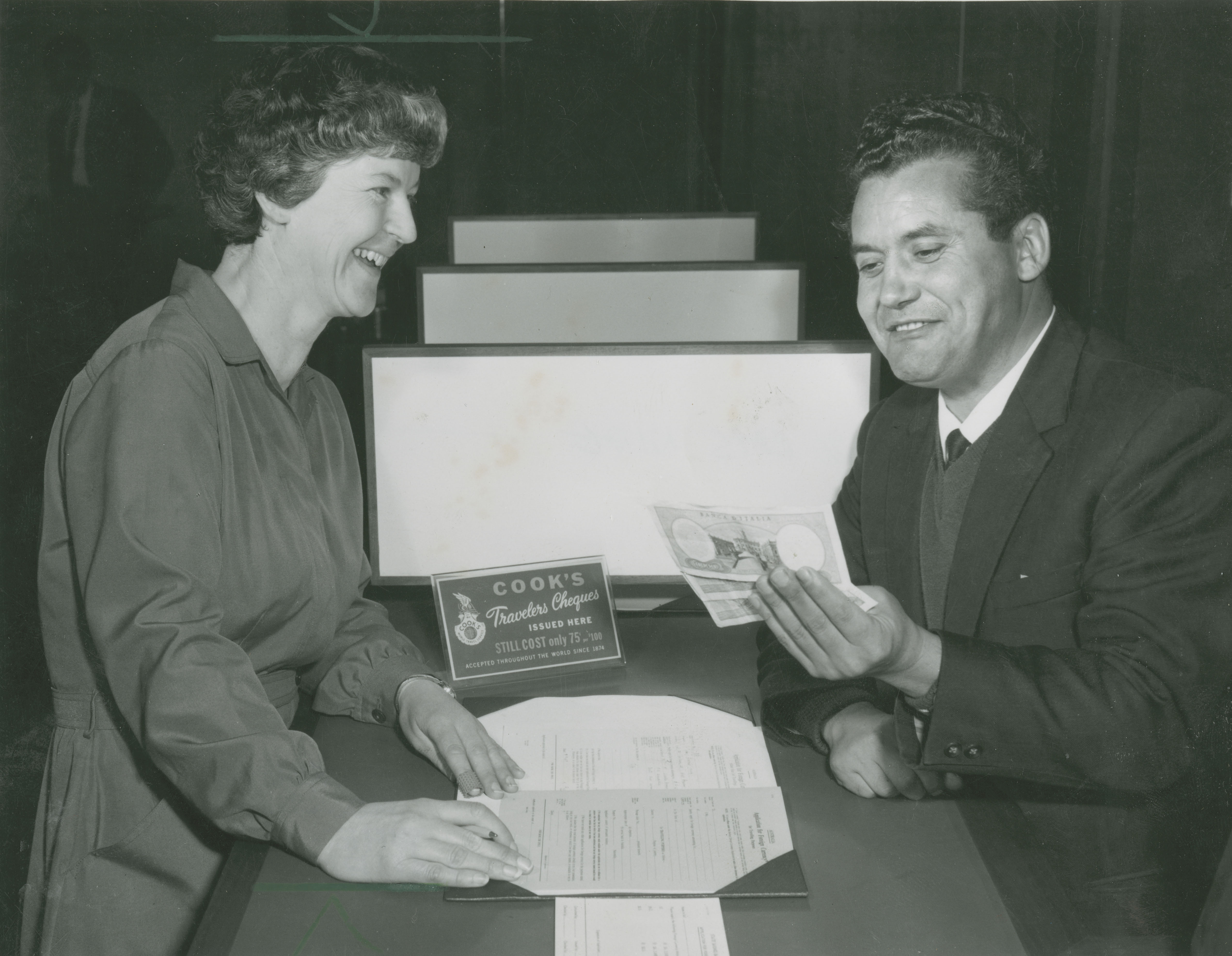 Miss Mac’ Stella McDonald of the Overseas Department with a customer.