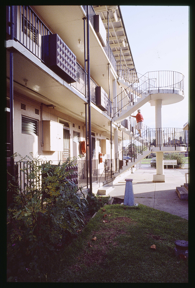 Coloured photo of a person walking up stairs at social housing