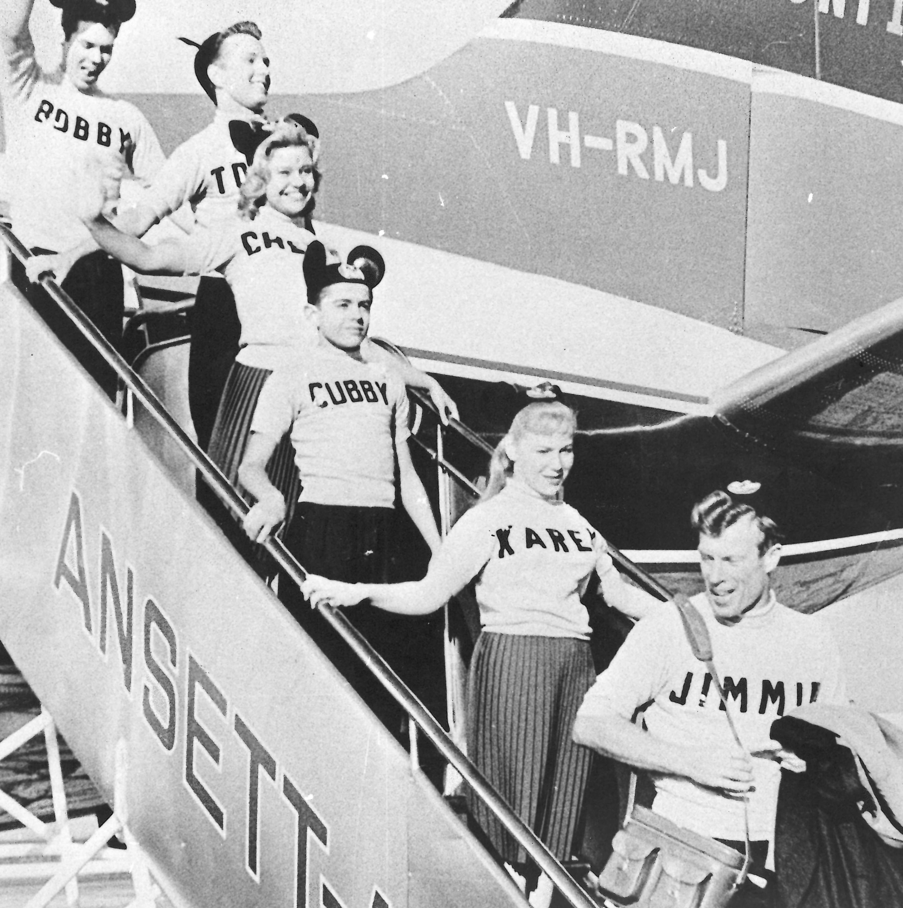 black and white photo of the mouseketeers disembarking the plan