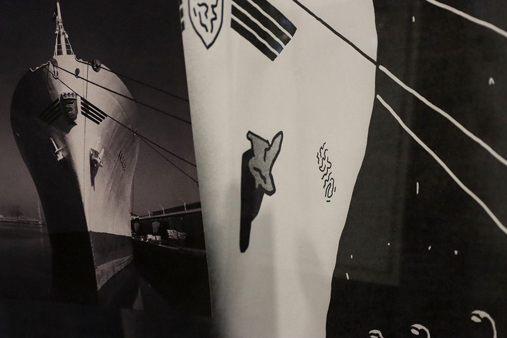 Black and white image of a photograph of a ship in front of a drawing of the same ship