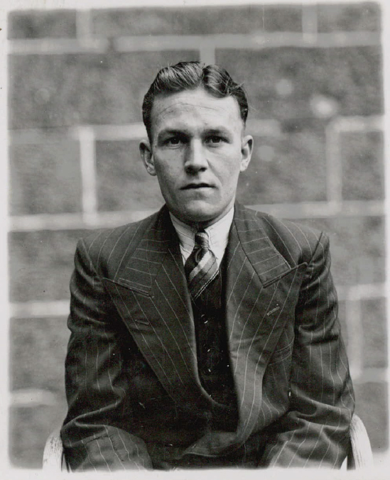 black and white photo of young man looking at the camera