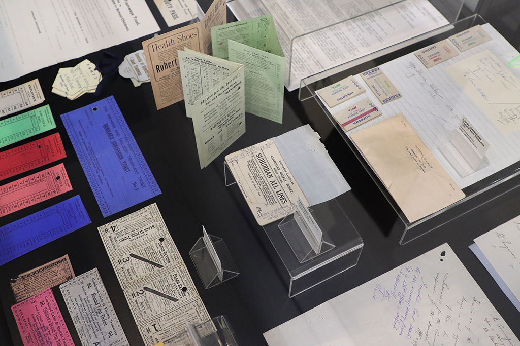 A close up of a display of archival records relating to transport tickets, including many colourful tickets.