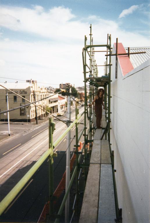 Megan Evans drawing the outline for the Women's Mural
