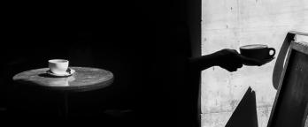 the shadow of a cup at a cafe