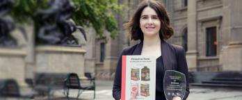 woman holding a book and trophy