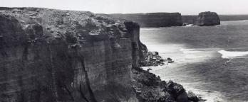 A page from the Vic Railways electrification scheme photo album black and white photo of rocky mountain and ocean