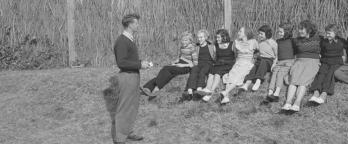 a group of children sitting on grassy ground