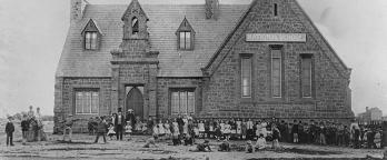 Exterior view of the National School. VPRS 14517/P0001/46, S90 Black and white photograph of a nineteenth century school building with children outside