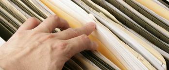 Stock Image hand searching suspension files