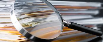 recordkeeping issues across government papers with a magnifying glass