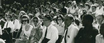a crowd of people seated watching an event