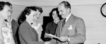 a man giving people certififcates