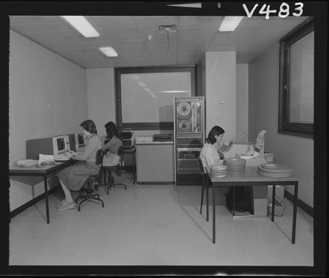 women working at old fashioned computers