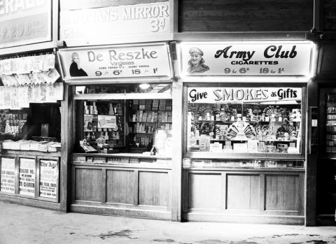 black and white photo of a train station kiosk