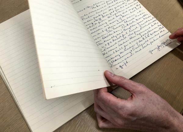 hand flipping through a diary