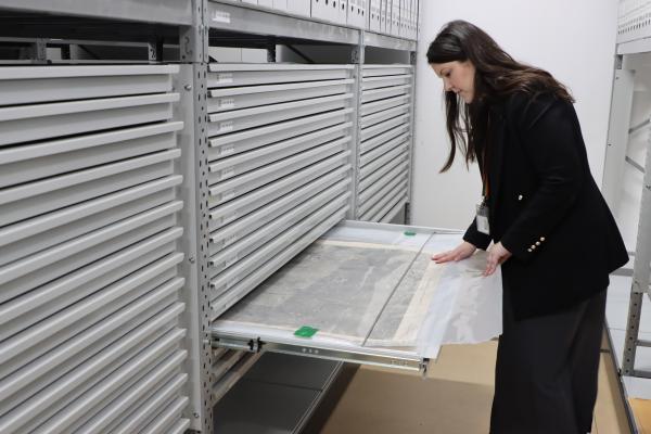 a woman looking at maps