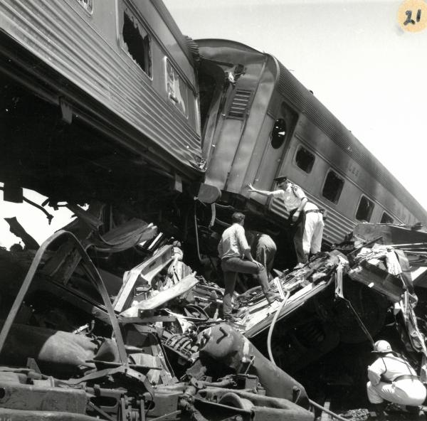 rescuers climbing the rubble of the train crash