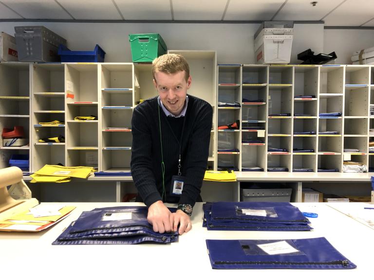 Mail being sorted by a RISE team member