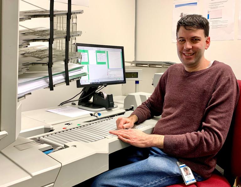 Documents being digitised by a Scanning Operator on the RISE team