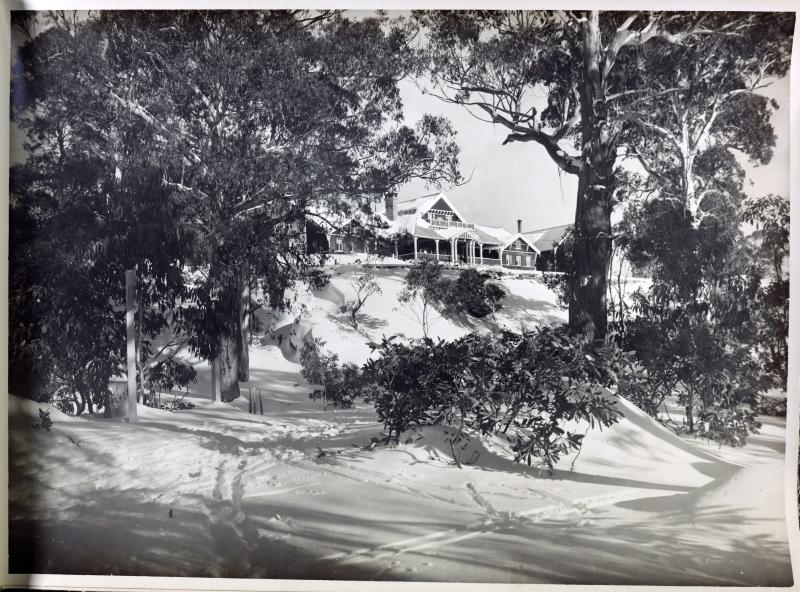 black and white photo of a building on a snowy mountain